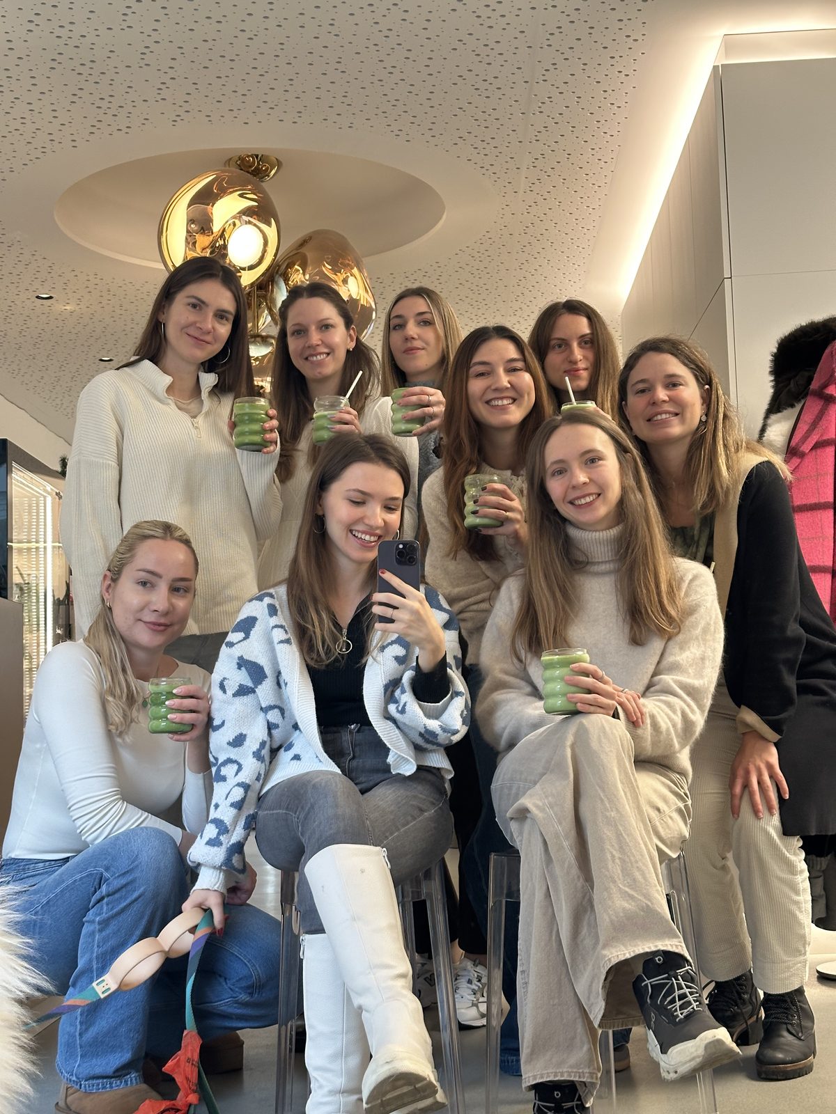 A group of girls holding matcha drinks